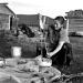 A Mongolian women cleans goat intestines to make some offals near Hovsgol lake