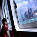 A young boy contemplates the Hong Kong central island from a shuffle boat